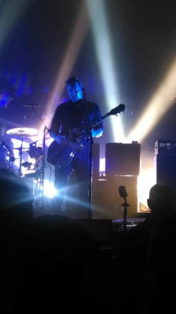 Frontman Josh Homme (center) and drummer Jon Theodore perform at Bayou Music Center