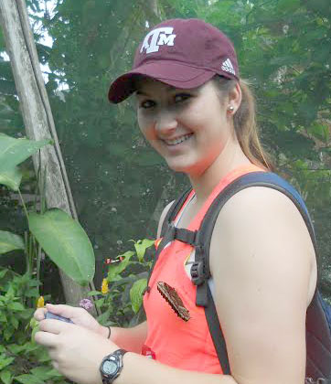 Former student Sarah Espinosa picks up a fluttering friend on the last school trip to Costa Rica.