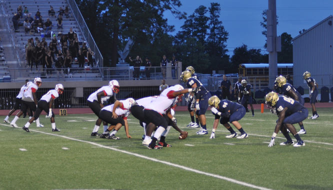 Cardinals face off against the Klein Collins Tigers across the line of scrimmage.