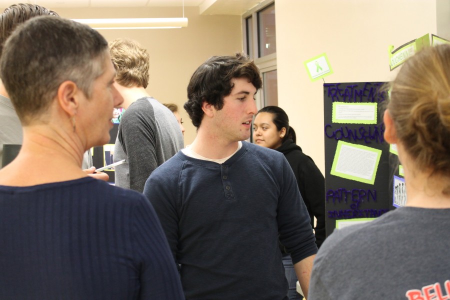 (from left to right) Loonam and Senior Ryan Levitt discuss his presentation on Duchenne Muscular Dystrophy.