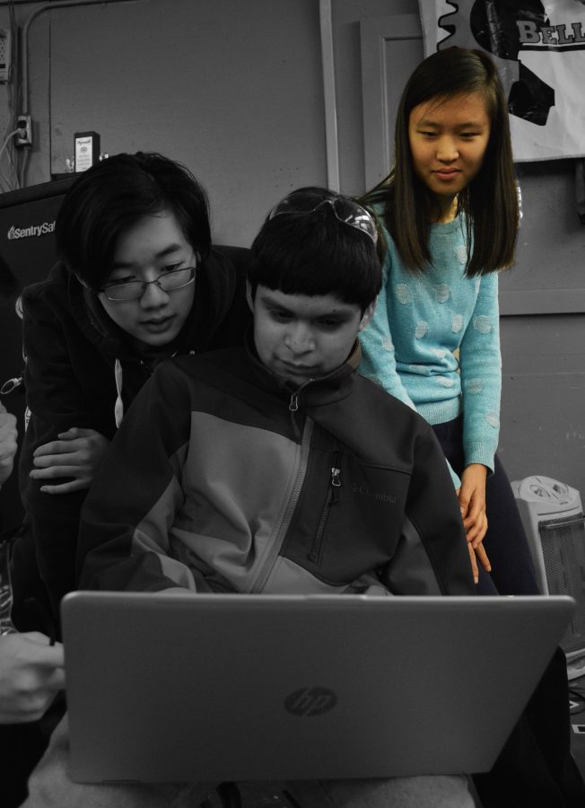 Sophomore Andrew Wu, sophomore Antonio Ruiz and junior Jenny Xin collaborate on robot design.