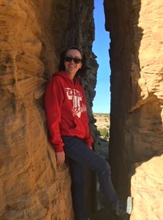 Kallie Cope leans against rocks in the Grand Canyon. 