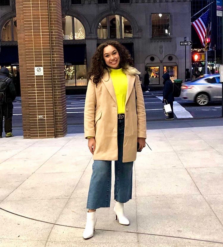 Junior Isabella Batarse wears a beige trench coat from Zara, a Banana Republic sweater, H&M jean flare pants, and white Banana Republic ankle boots.