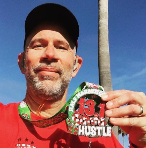 Wearing his BHS gear, McDonough finishes the Santa Hustle Half Marathon in Galveston at 1:53:38. McDonough, who is an avid runner, says that training is his favorite hobby. 