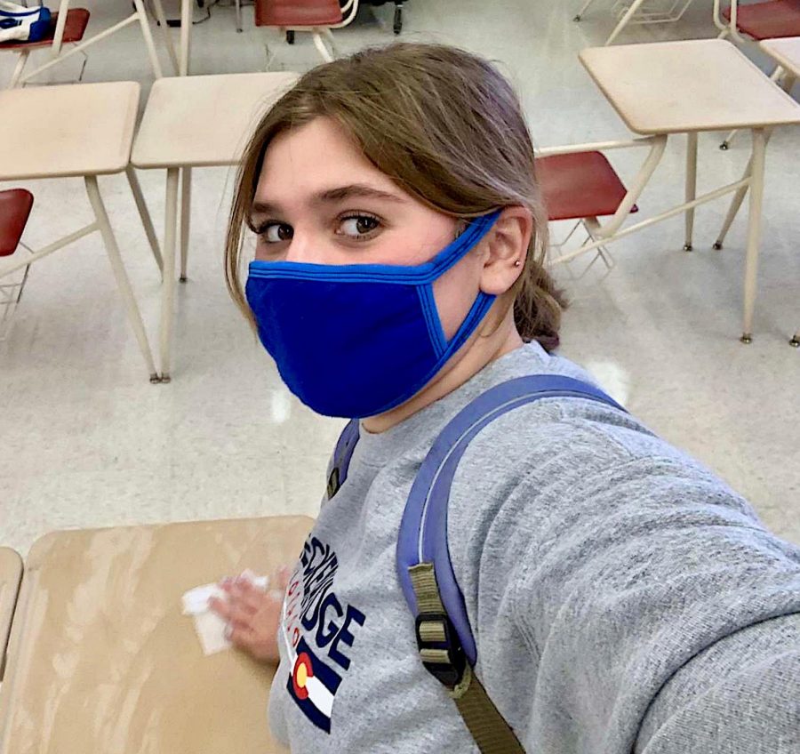 Wiping down the desks has become a part of junior Amber Alvarez’s school routine. It is one of the protocols students follow while attending in-person school. 