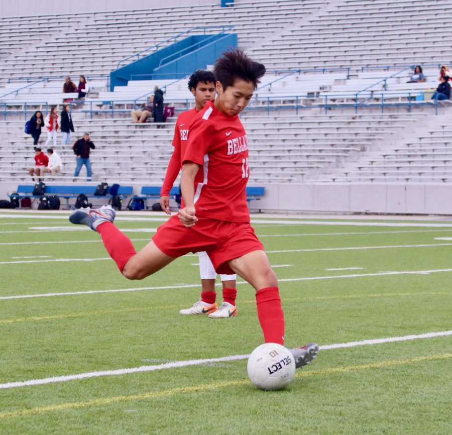 Ricky Kai shoots the soccer in preparation for the game against Lamar at Delmar Stadium during his sophomore season.