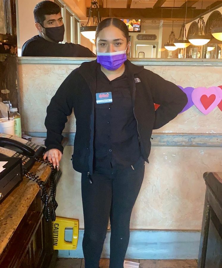 Senior Lizbeth Gonzales stands at the entrance of Molina’s Cantina during a break. She works a nine-hour shift five days a week  to help herself and help her mom financially. 