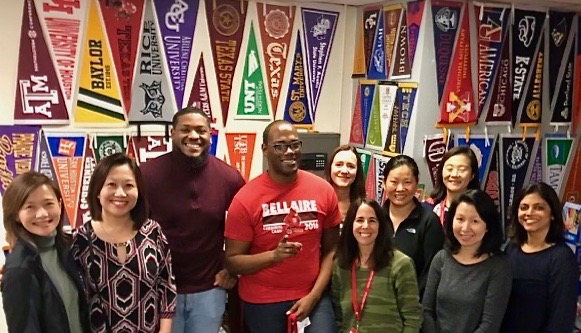 Parents gather around College Advisors Davonta Lee and Marcus Stewart in the College Career Center after a meeting during the 2019-20 school year. 