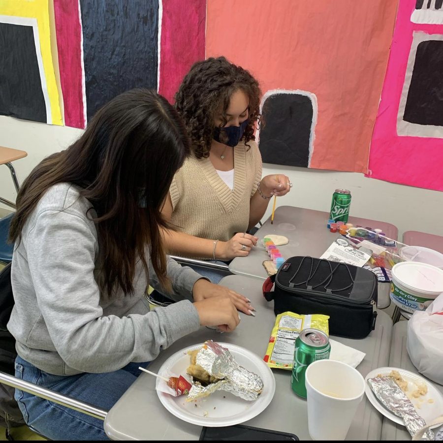 Seniors Marie Garcia and Isabella Batarsé paint skulls out of clay. They first mold the shape then paint them after waiting for them to dry.