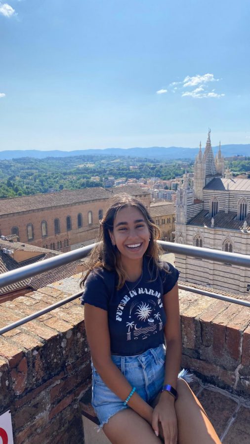 Angelina Pascali rests at the top of the Torre del Mangia after climbing the 400+ steps leading up. Pascali studied abroad in Italy this summer.