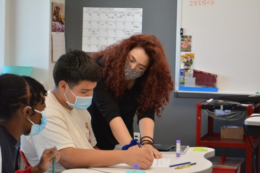 Algebra I teacher Maggie Jernigan, in room 1718, explains how to solve a variable for her 4th period class. Jernigan walks around and guides students through their assignment. As a floating teacher, she will be in another class next period.