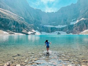 Chen reaches the final destination of the eleven-mile Iceberg Lake trail in Glacier National Park. Hikers can walk a few feet into the 30 degree melted glacier water, or they can opt to wade several feet in and submerge themselves completely.