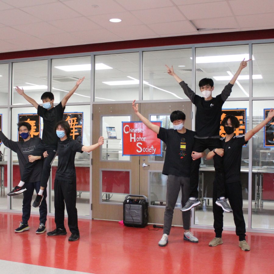 Second place winners pose at the end of their performance to a remix of Renegade. Members of the group: juniors Theo Hunt, Xianliang Kong, Brandon Sun and Brian Zhuang got two of their friends from the audience to carry for their finale.