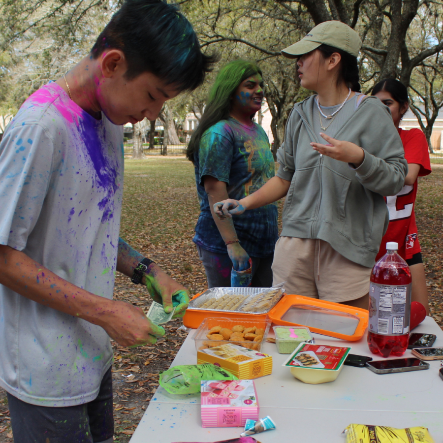 Students gather at Karl Young park to celebrate the Holi festival hosted by the Hindu National Honor Society and South Asain Student Association. Holi powder and traditional Indian treats were sold to fundraise for future club events and T-shirts. The materials were bought by the students and sponsored by Safeway Driving.