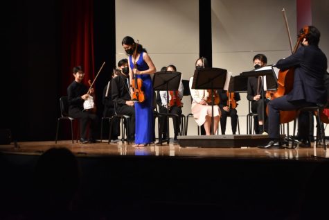 Vice President and senior Heather Gan takes a bow after the completion of the concert. Gan, the violin section leader, led the violins in their performance of Encanto, Cello Concerto Mvt. 1 & 2 and The Magical World of Pixar.