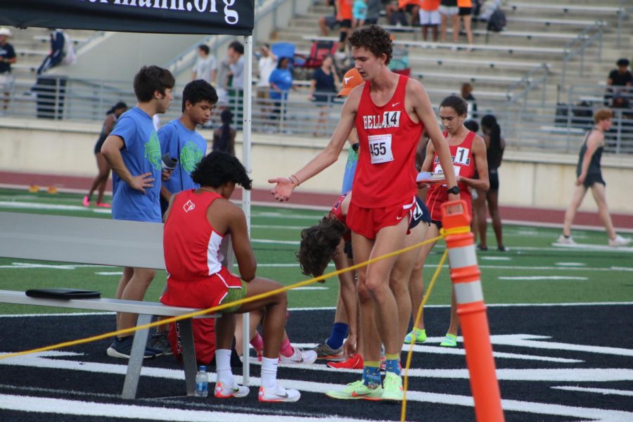 Senior Dylan Ballard congratulates junior Zain Hamdani for placing 7th in the 1600 meter mens race. Ballard and Hamdani competed against 12 other local schools including Strake Jesuit, Seven Lakes and Memorial.