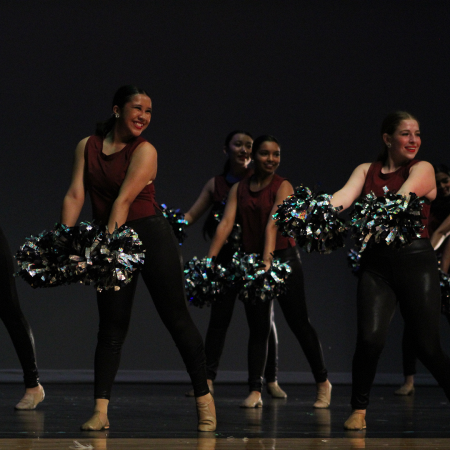 Junior varsity performs a pom routine “Pour Some Sugar on Me” choreographed by senior and captain Natalie Faris and junior and captain Laura Cheng. Sophomore Valerie Perez, Smruthi Garlapati, Angelin Zhen and freshman Addison Berger flick their poms back and forth as the audience cheers.