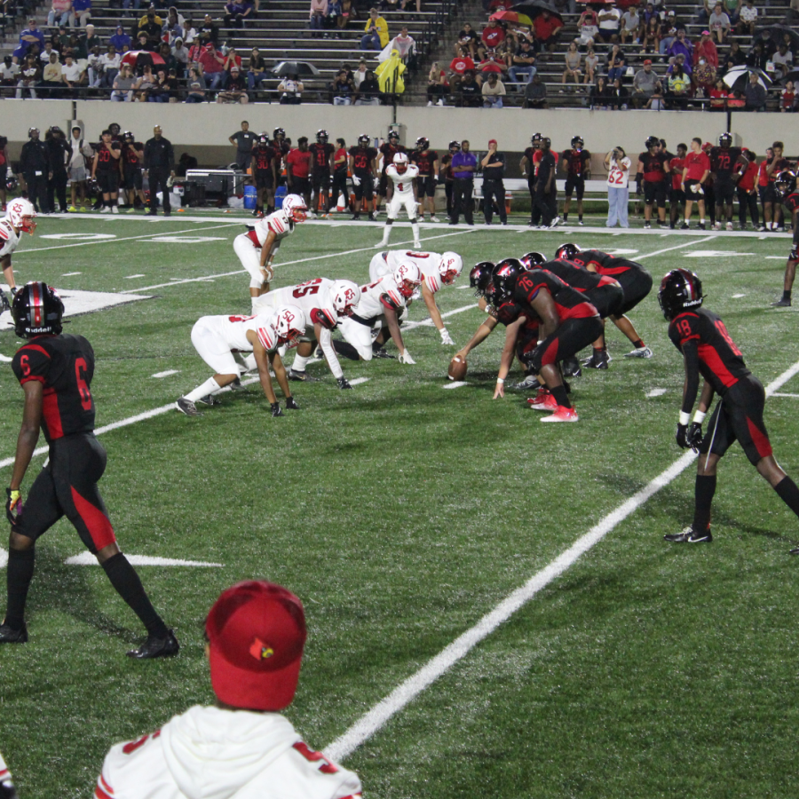 The+football+players+stand+in+formation%2C+preparing+for+the+kickoff.+The+Bellaire+Cardinals+play+the+Goose+Creek+Memorial+Patriots.