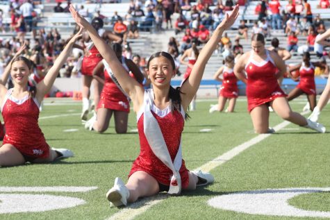 Laura Cheng does the splits during the Belles Halftime performance. Cheng is colonel of the dance team.