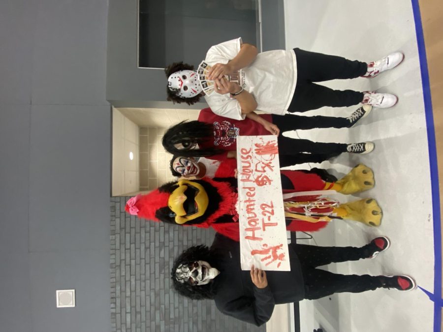 Spanish Club actors encourage Ralphy to buy a ticket for the haunted house. During lunch on Friday, Oct. 28, actors walked around main street promoting the event.