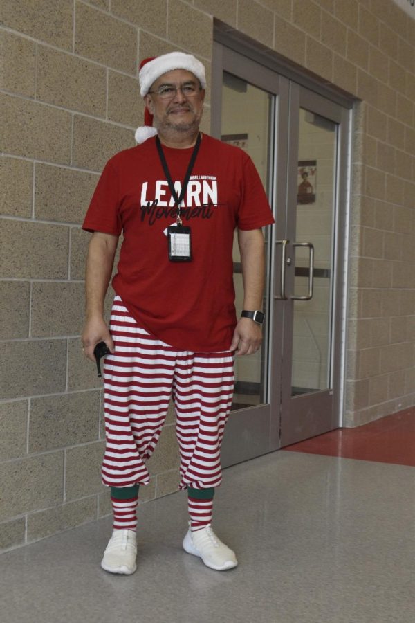 Assistant Principal Jesse Rivera wears a full red-and-white look for Friday’s Candy Cane Day theme. He went back to his office and grabbed his Santa hat to complete his look for the photo.