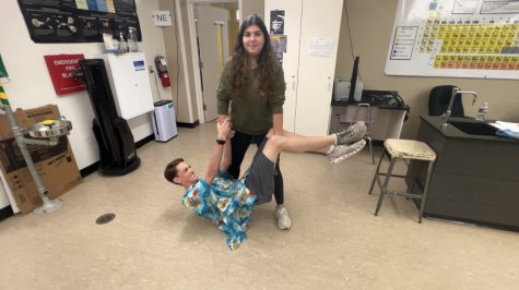 Senior Sofia Abdalla deadlifts Owen Bell during Cardinal hour in 1603. Sofia has been deadlifting her friends and recording it on her phone.