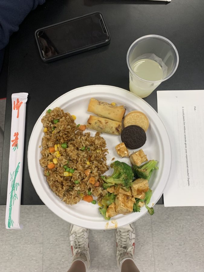 Mmmm! A packed plate full of vegan foods includes vegetable fried rice, egg rolls, Oreos, and seared broccoli with Tofu.