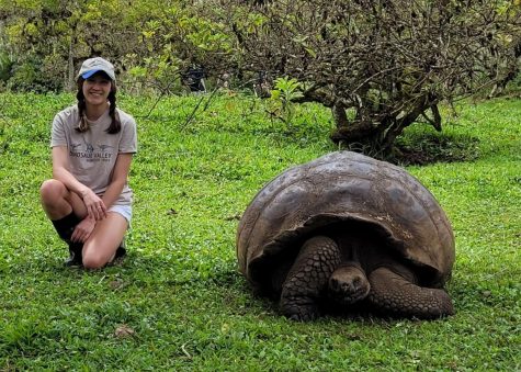 Senior Victoria Allen poses next to a Galapagos giant tortoise. Allen said the experience opened [her] eyes to the untouched beauty of our planet, and encouraged her to become more sustainable.