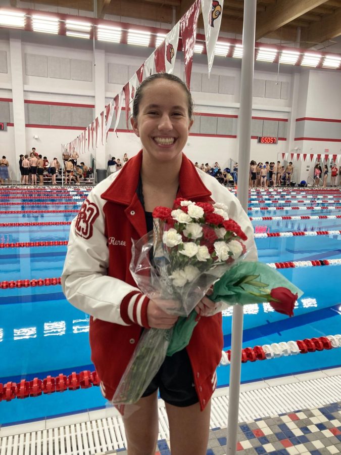 Senior Renee Navarro stands with a bouquet of flowers at a swim meet. Navarro said that because her sophomore year was online, she had to create a new working mindset for her junior year.