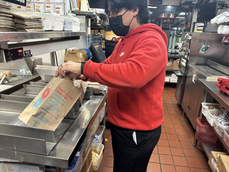 Evelios Santos works his night shift on Wednesday, Dec. 14 where he has to prepare ingredients, cook food and pack it. He usually works 3-4 days a week after school along with his brother. (Photo provided by Alfredo Santos)