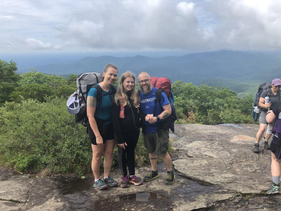 Raina Blesi and her parents on the Appalachian mountains. They are stopped at the top of one of the tallest mountains for photos and lunch. 