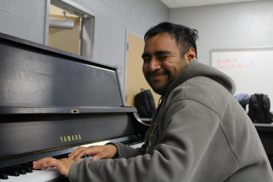 Senior Miguel Delgado-Olguin squeezes his eyes shut in joy as he plays the piano.