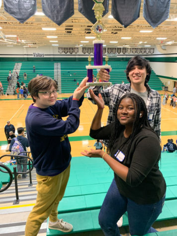 (from left) JCL Co-President and senior Arthur Fowler, freshman Kate Oguntoyinbo and JCL Co-President and junior Jermy Scarpetta hold up JCLs fifth place trophy from the JCL Area A competition. Members also placed in individual categories including dramatic interpretation, the decathlon, Roman life, ancient geography, Latin literature, Latin vocabulary, and the softball throw.
