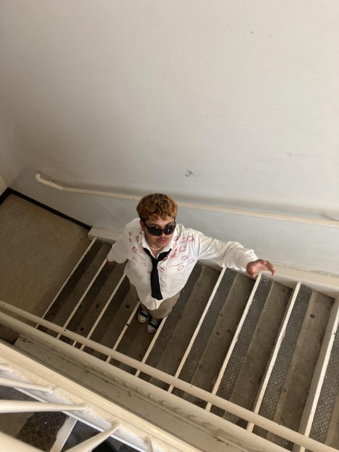 Hector Vazquez is pictured posing on a stair well in a special outfit he designed for Valentines Day. Vazquezs passion for fashion has helped him to maintain motivation to come to school. (Photo provided by Hector Vazquez)