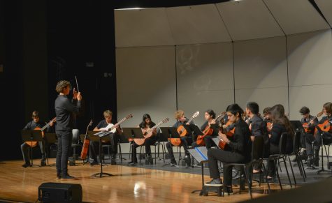 Sophomore Luca Rainusso conducts the junior varsity class during their captivating performance of Habanera, accompanied by five additional pieces led by both students and their 5th-period guitar teacher, Mr. Grigassy.