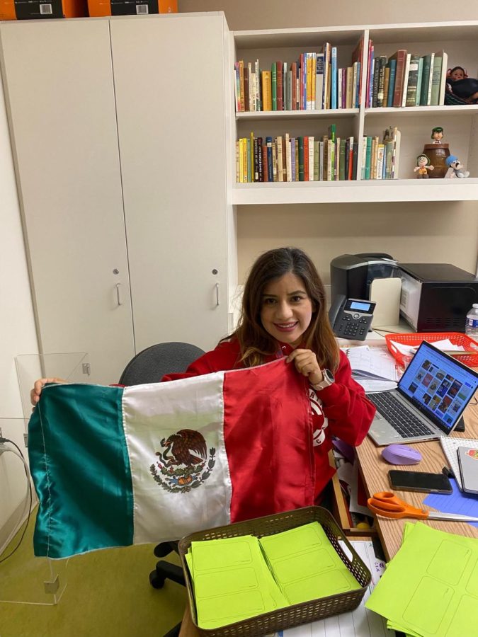 Lucy Aguilar celebrates Mexico’s Independence Day in her classroom. Spanish Club members stopped by to take pictures with the flag. (Photo provided by Lucy Aguilar)