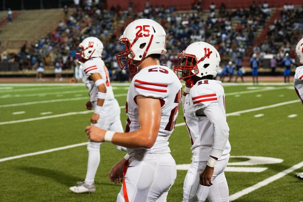 Juniors Michael Galleon, Rocco Grazier, and Dexter August (left to right) get ready to enter the game on defense during the third quarter of action, when Bellaire was trailing 14-7.