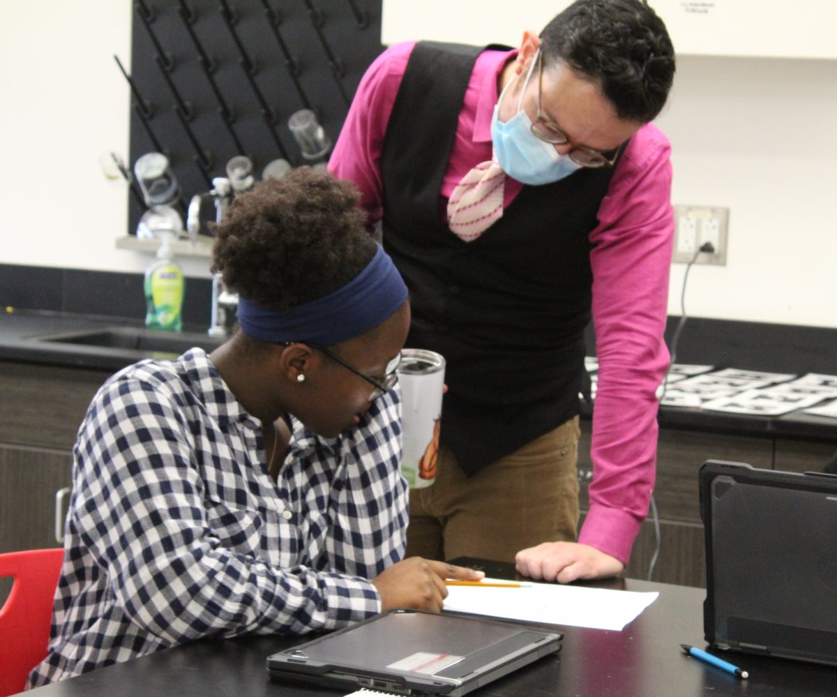 OnRamps chemistry teacher Robert Morales assists sophomore Bethanie Imboulaon on an assignment during fourth period. The class focused on density calculations and received worksheets.