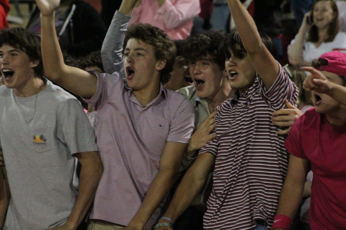 Students celebrate as the Cardinal football team wins the game.