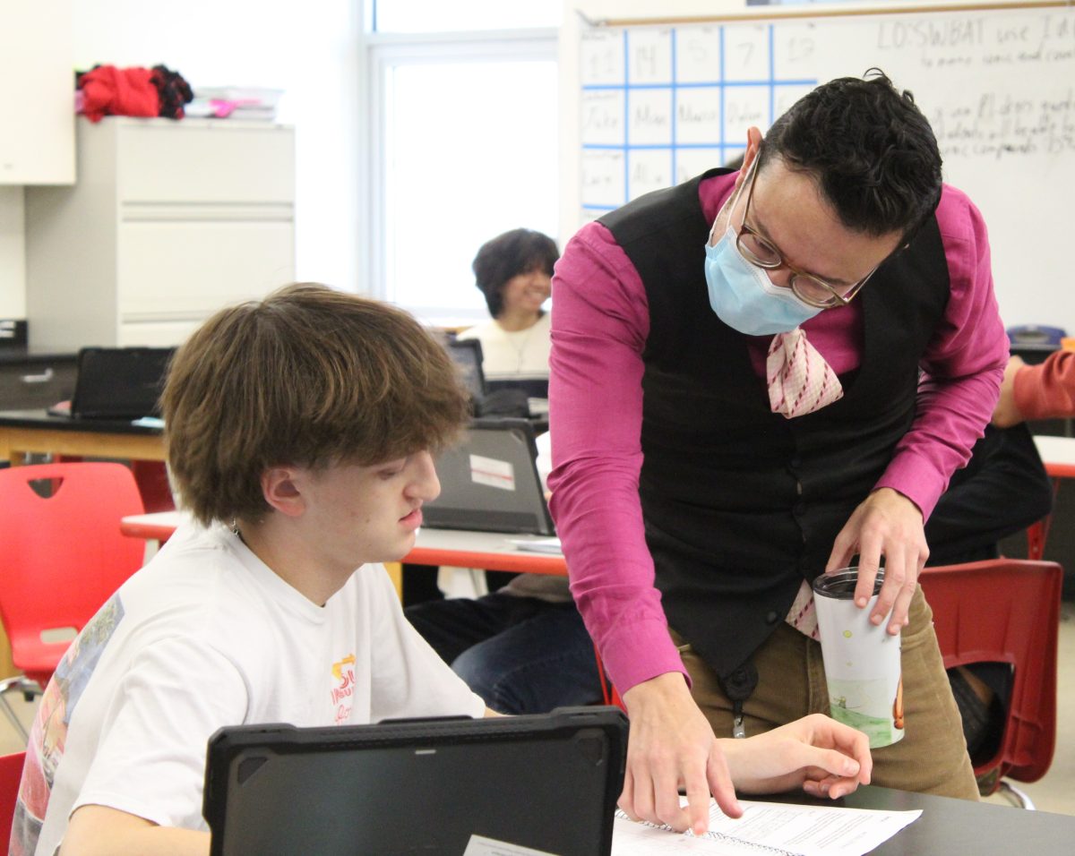 OnRamps Chemistry teacher Robert Morales guides sophomore Dunham Ludwick on an assignment during fourth period. The class focused on density calculations and received worksheets.