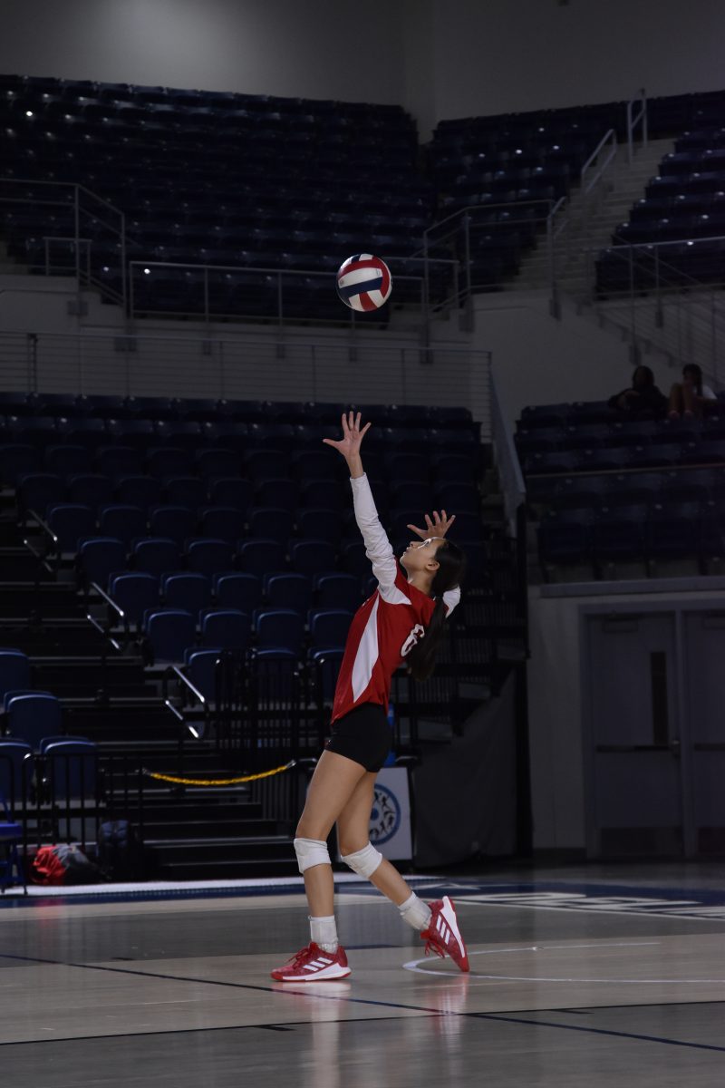 Freshman Olivia Wang serves against Heights. The Lady Cardinals rallyed down 0-2 to get their first victory of the district season.