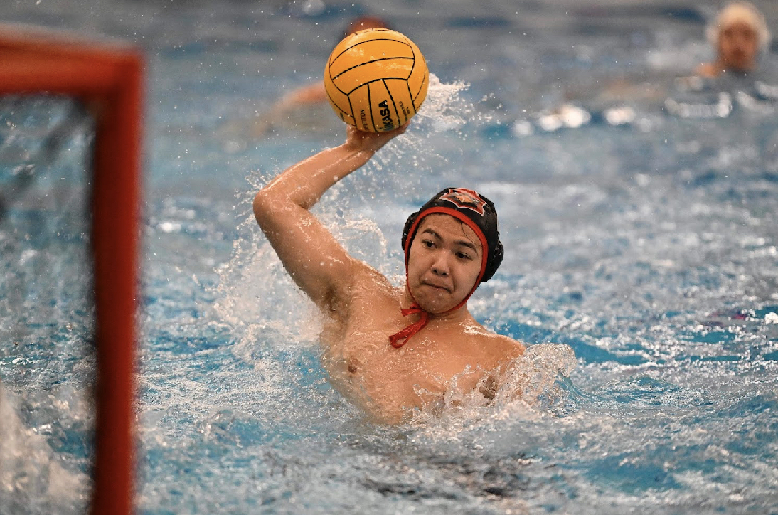 Sophomore Christopher Gee propels himself out of the water, all his hard work tested during the Cardinals’ game on Sept. 16 against Westside. Gee and the water polo team’s resilience will launch them into the playoffs. 