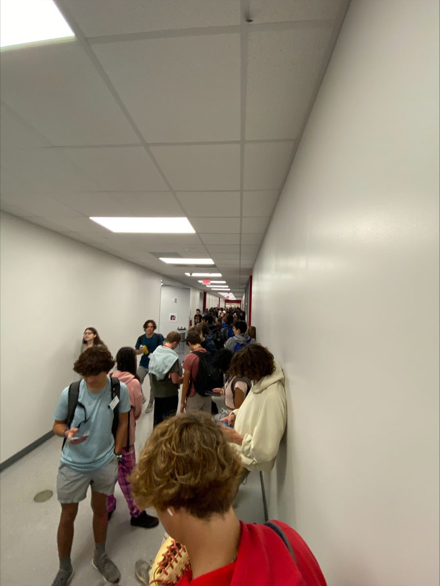 People waiting in a long line after being told to go to the tech room to find out which room to go to.  The main lists were both not fully alphabetized and  missing a lot of names.