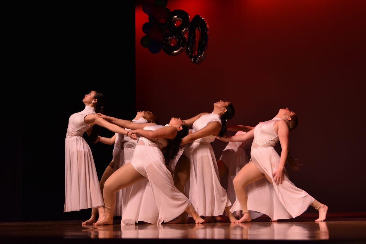 The Belles modern division, Honor Corps, performs a dance at the Belles 2023 Spring Show. Junior Allyson Nguyen is at the front with the other dancers grabbing her arms as if holding her back.