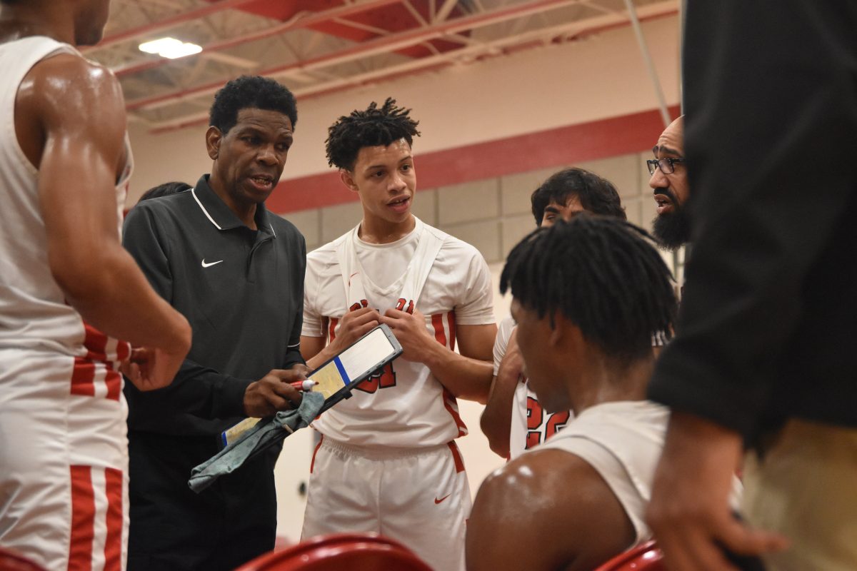 Head coach Bruce Glover speaks to the Cardinals during a time out. His coaching was integral to the Cardinals capturing a 13-point victory over El Campo.
