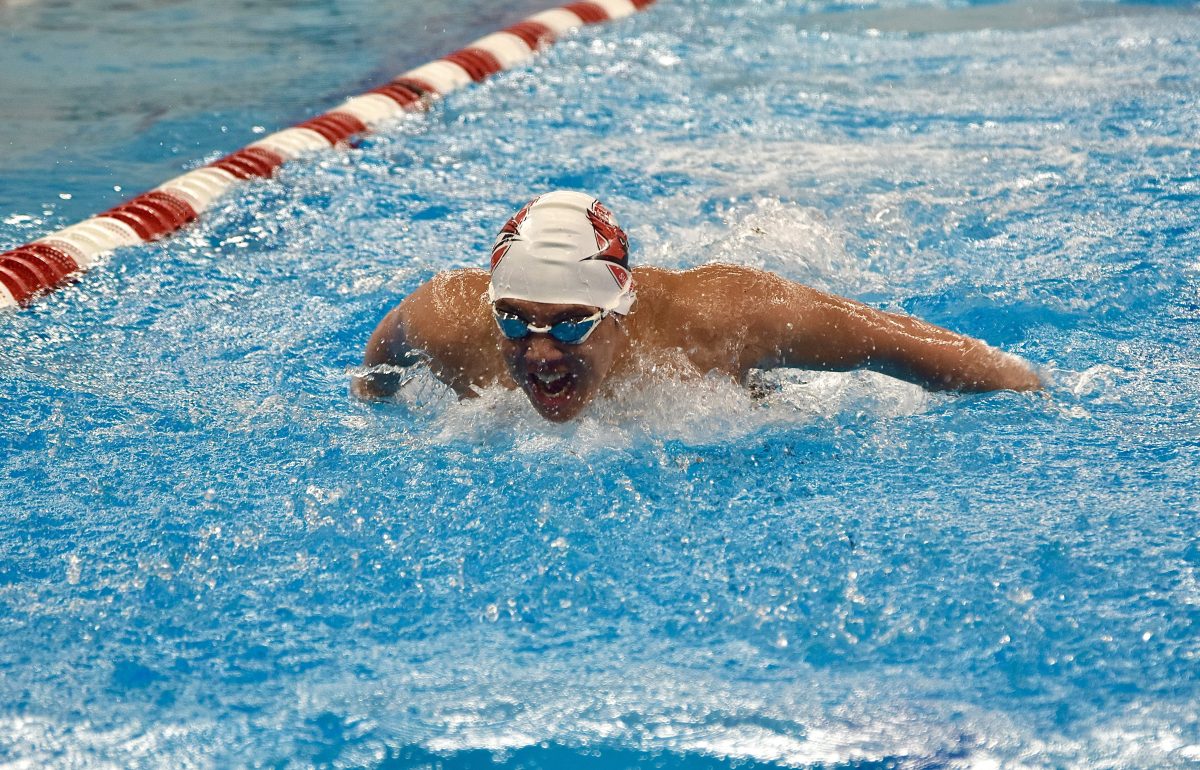 Sophomore Christopher Gee fights for first in the butterfly event. You have to train by yourself or train with your team to get better, he said.