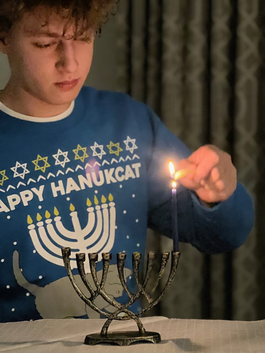 Freshman+Ike+Diamond+lighting+his+Hanukkiah.+This+photo+was+taken+on+the+first+night+of+Hanukkah+this+year.