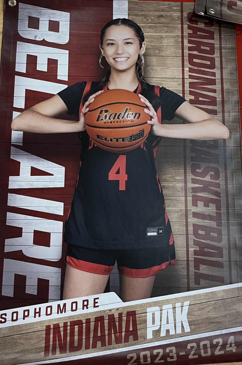 Sophomore Indiana Paks varsity basketball poster hangs in the performance gym. This is her second year playing on varsity.