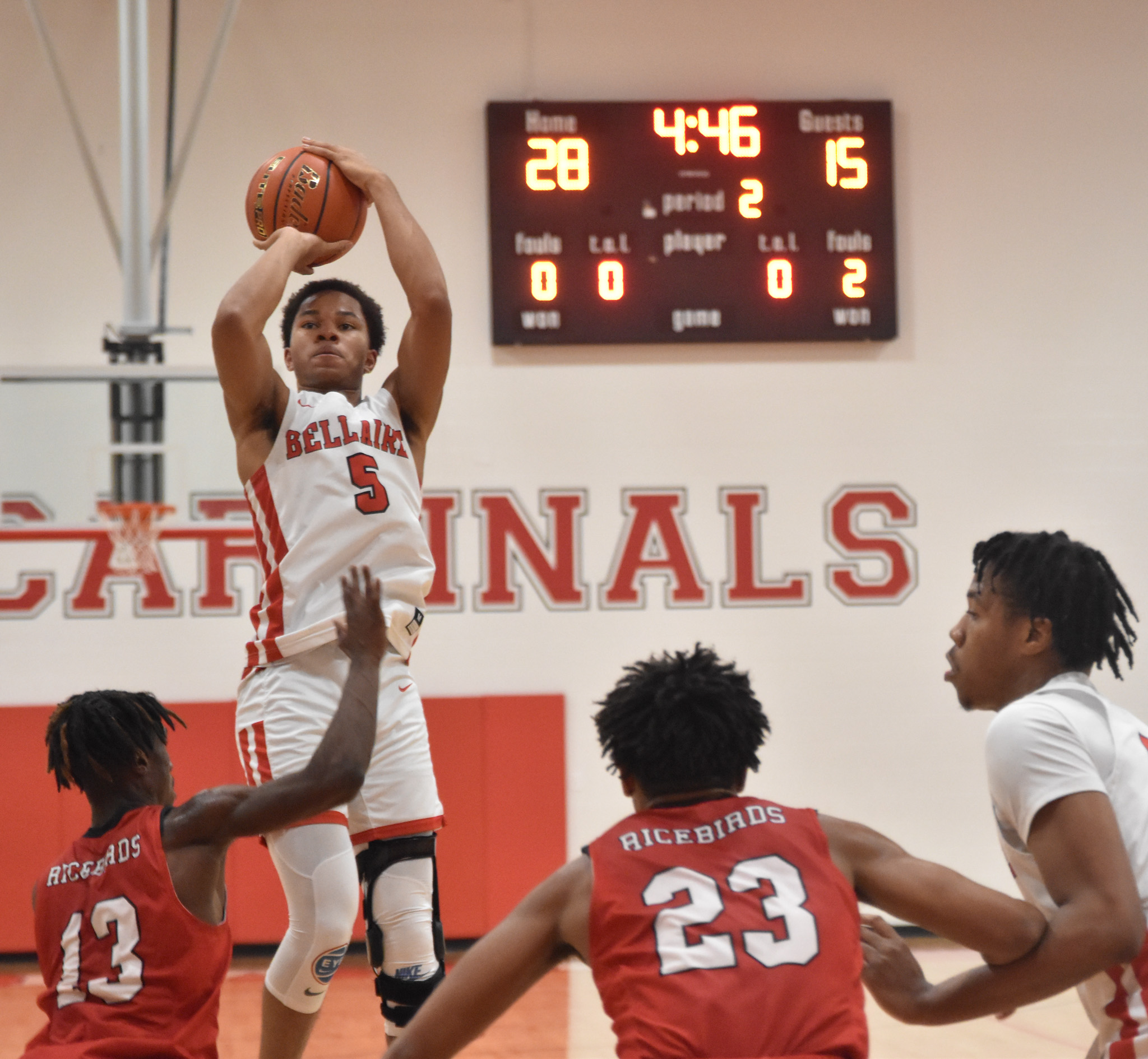 Junior Kohlman Dutton rises over El Campo defenders for a jumpshot. His offseason rehab culminated in his first game in ten months.