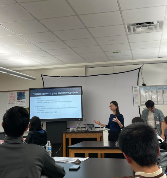 Graduate student Jennifer Wang and Matthew Yeh from MIT and Harvard present the program schedule and lesson plans to students.